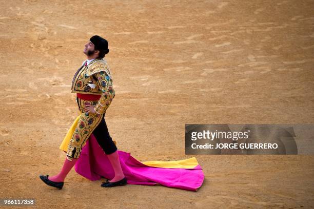 Spanish matador Morante de la Puebla walks holding his capote during the Corpus bullfighting festival at the Granada bullring on June 2, 2018.