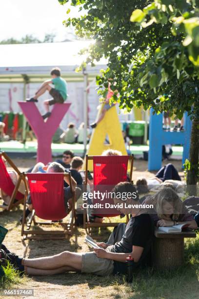 Visitors reading in the sunshine at the Hay Festival on June 2, 2018 in Hay-on-Wye, Wales.
