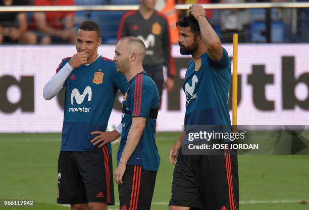Spain's forward Rodrigo Moreno , midfielder Andres Iniesta and forward Diego Costa attend a training session of Spain's national football team at La...