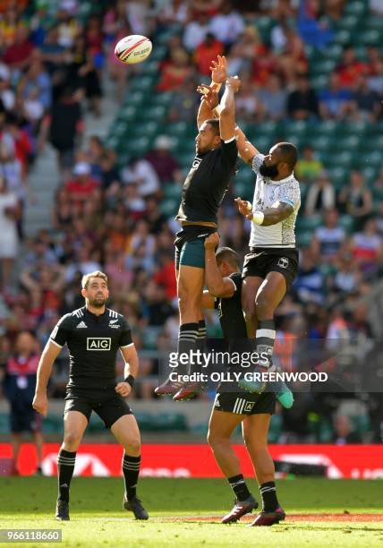 Fiji's Semi Radradra and New Zealand's Tone Ng Shiu compete for the ball during the pool A match between Fiji and NewZealand on the first day of the...