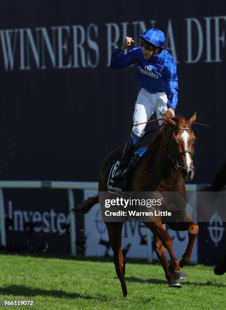 William Buick ridding Masar celebrates crossing the line and winning the Investec Derby during the Investec Epsom Derby Day at Epsom Downs on June 2,...