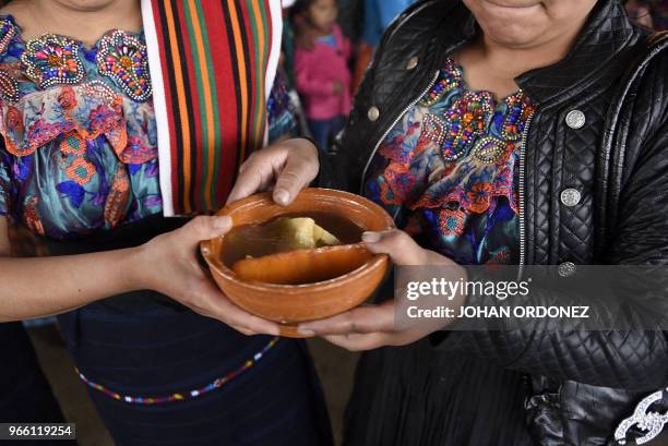 Indigenous people eat before the burial of Claudia Gomez, a 19-year-old Guatemalan woman who was allegedly shot and killed by a U.S. Border patrol...