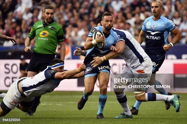 Montpellier's New Zealander fly-half Aaron Cruden is tackled during the French Top 14 final rugby union match between Montpellier and Castres at the...