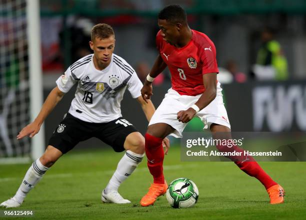 David Alaba of Austria and Joshua Kimmich of Germany battle for the ball during the International Friendly match between Austria and Germany at...