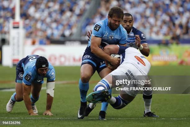 Castres' French flanker Anthony Jelonch is is tackled by Montpellier's South African centre Francois Steyn during the French Top 14 final rugby union...