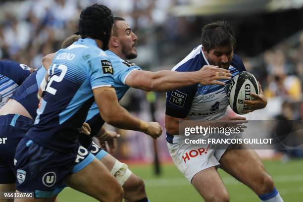 Castres' French flanker Anthony Jelonch runs to evade Montpellier's French number 8 Louis Picamoles during the French Top 14 final rugby union match...