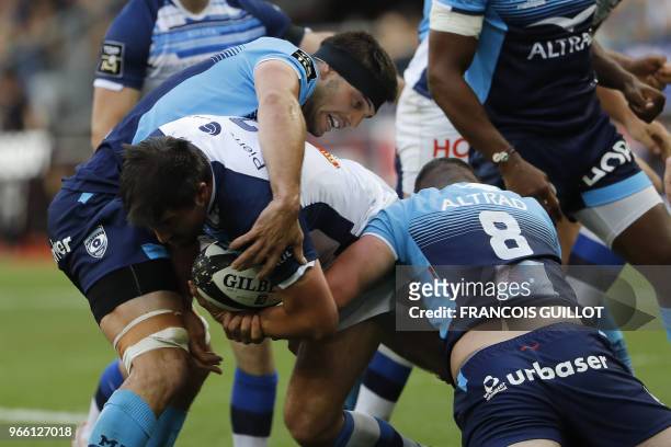 Castres' French flanker Anthony Jelonch is is tackled by Montpellier's French flanker Kelian Galletier and Montpellier's French number 8 Louis...