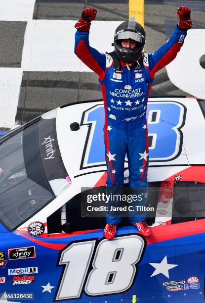 Kyle Busch, driver of the Comcast Salute to Service/Juniper Toyota, celebrates after winning the NASCAR Xfinity Series Pocono Green 250 Recycled by...