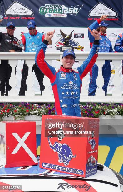 Kyle Busch, driver of the Comcast Salute to Service/Juniper Toyota, celebrates in Victory Lane after winning the NASCAR Xfinity Series Pocono Green...