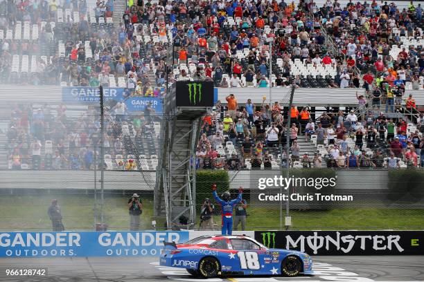 Kyle Busch, driver of the Comcast Salute to Service/Juniper Toyota, celebrates after winning the NASCAR Xfinity Series Pocono Green 250 Recycled by...