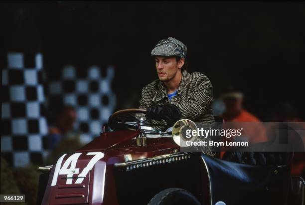 Benetton driver Jenson Button of Great Britain drives a vintage car in vintage clothing during the Goodwood Festival of Speed held in Goodwood,...