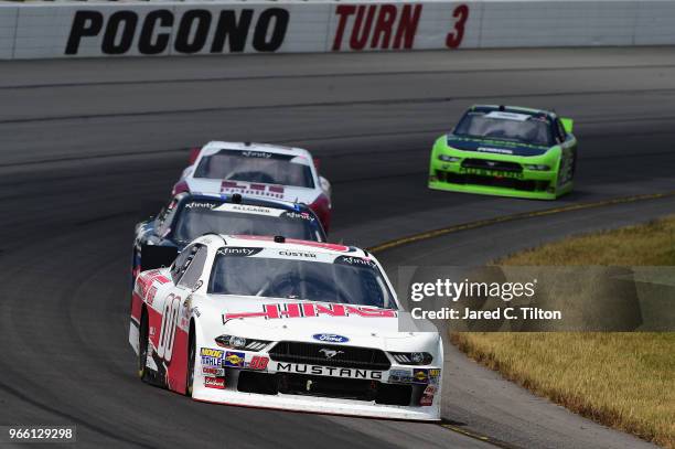 Cole Custer, driver of the Haas Automation Ford, leads a pack of cars during the NASCAR Xfinity Series Pocono Green 250 Recycled by J.P. Mascaro &...