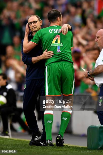 John O'Shea of the Republic of Ireland hugs Martin ONeill, Manager of The Republic of Ireland as he is substituted off for the final time during the...