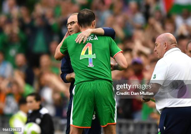 John O'Shea of the Republic of Ireland hugs Martin ONeill, Manager of The Republic of Ireland as he is substituted off for the final time during the...