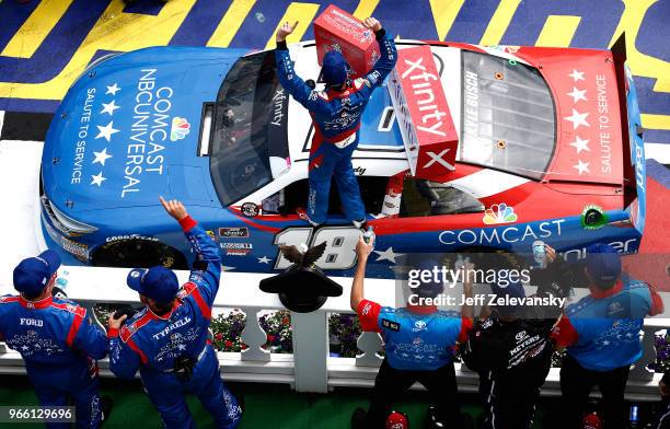 Kyle Busch, driver of the Comcast Salute to Service/Juniper Toyota, celebrates in Victory Lane after winning the NASCAR Xfinity Series Pocono Green...