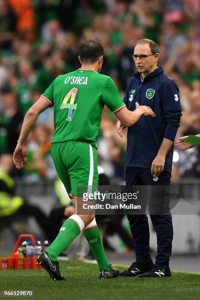 John O'Shea of the Republic of Ireland shakes hands with Martin ONeill, Manager of The Republic of Ireland after being substituted off for the final...