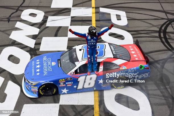 Kyle Busch, driver of the Comcast Salute to Service/Juniper Toyota, celebrates after winning the NASCAR Xfinity Series Pocono Green 250 Recycled by...