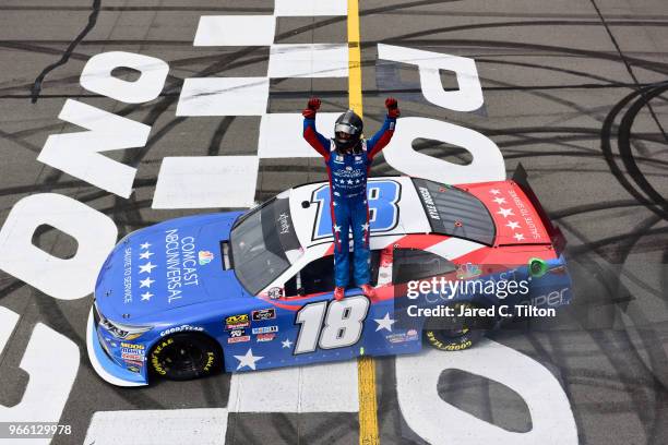 Kyle Busch, driver of the Comcast Salute to Service/Juniper Toyota, celebrates after winning the NASCAR Xfinity Series Pocono Green 250 Recycled by...