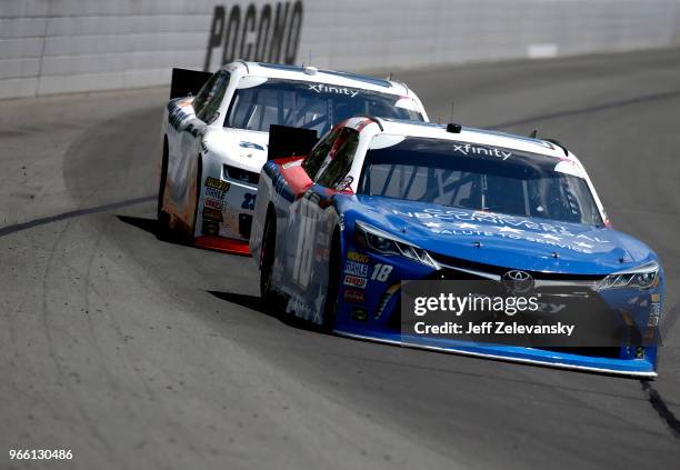 Kyle Busch, driver of the Comcast Salute to Service/Juniper Toyota, leads Chase Elliott, driver of the Allegiant Chevrolet, during the NASCAR Xfinity...