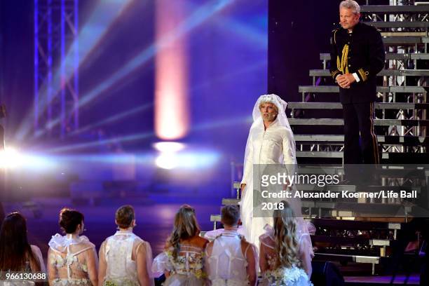 Conchita Wurst and Herbert Foettinger are seen on stage during the Life Ball 2018 show at City Hall on June 2, 2018 in Vienna, Austria. The Life...