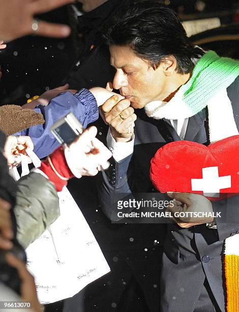 Indian actor Shah Rukh Khan kisses a fan's hand as he arrives for a photocall for his film My Name is Khan during the 60th Berlinale Film Festival in...