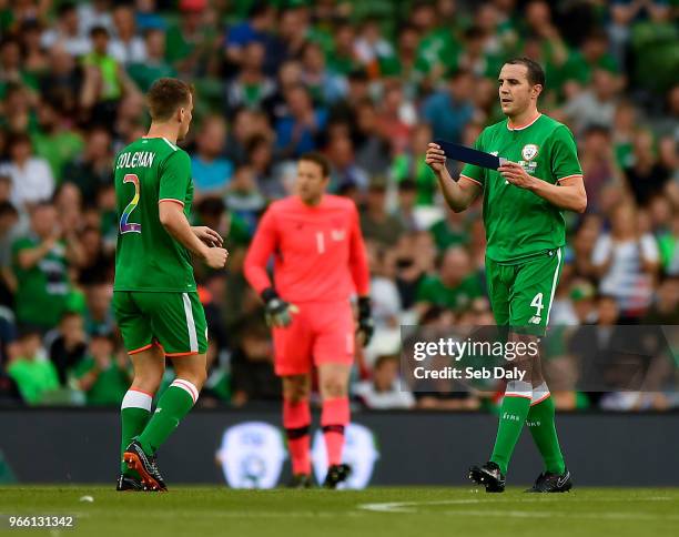 Dublin , Ireland - 2 June 2018; John O'Shea of Republic of Ireland hands Seamus Coleman the captain's armband before being substituted during the...