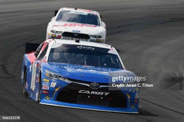 Kyle Busch, driver of the Comcast Salute to Service/Juniper Toyota, leads Cole Custer, driver of the Haas Automation Ford, during the NASCAR Xfinity...