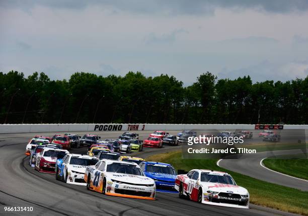 Chase Elliott, driver of the Allegiant Chevrolet, and Cole Custer, driver of the Haas Automation Ford, leads the field during the NASCAR Xfinity...