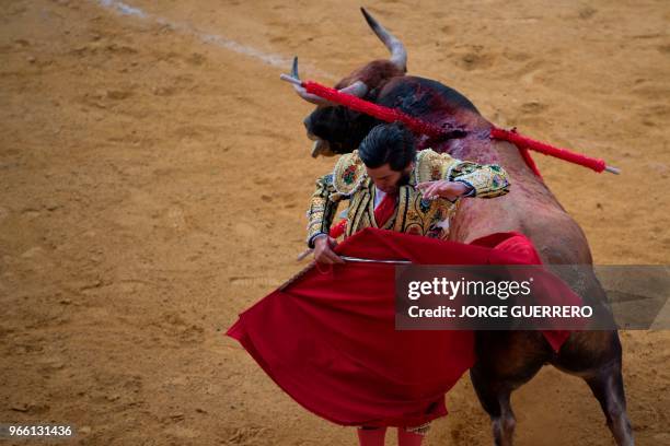 Spanish matador Morante de la Puebla performs a pass with muleta on a bull during the Corpus bullfighting festival at the Granada bullring on June 2,...
