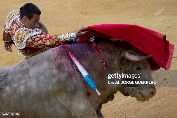 Spanish matador Jose Maria Manzanares performs a pass with muleta on a bull during the Corpus bullfighting festival at the Granada bullring on June...