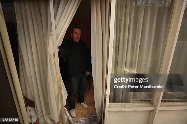 Resident looks out from the back door of a flat on the Heygate housing estate near Elephant and Castle on February 11, 2010 in London, England. The...