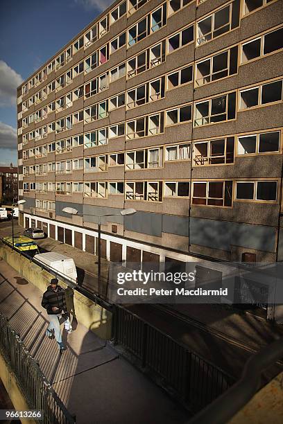 Man walks in late afternoon sunshine on the Heygate housing estate near Elephant and Castle on February 11, 2010 in London, England. The Heygate...