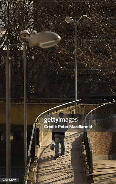 Man walks in late afternoon sunshine on the Heygate housing estate near Elephant and Castle on February 11, 2010 in London, England. The Heygate...
