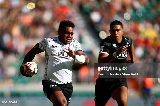 Josua Tuisova of Fiji breaks free to score a try during the pool match between Fiji and New Zealand on day one of the HSBC London Sevens at...