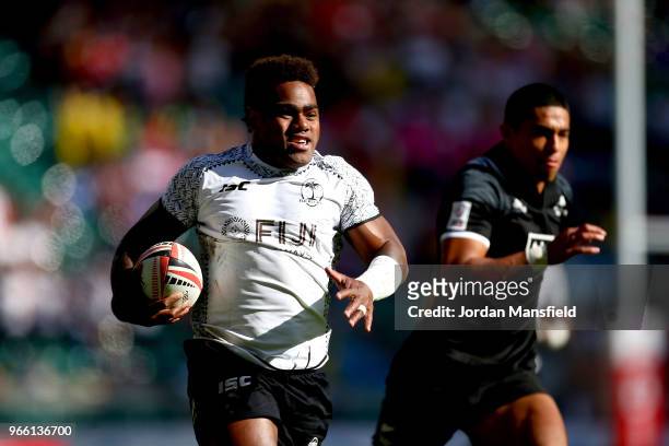 Josua Tuisova of Fiji breaks free to score a try during the pool match between Fiji and New Zealand on day one of the HSBC London Sevens at...