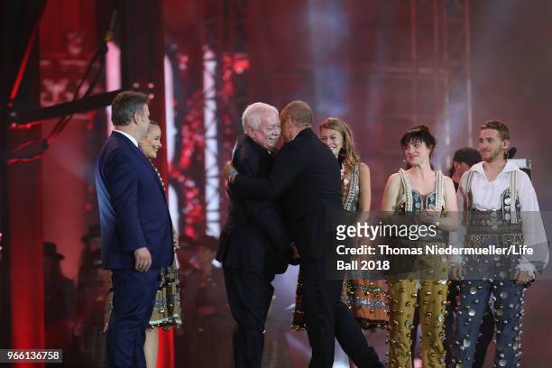 Former Viennese mayor Michael Haeupl embraces Life Ball organizor Gery Keszler on stage during the Life Ball 2018 show at City Hall on June 2, 2018...