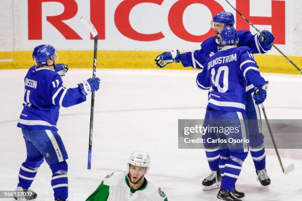 Josin Holl of the Marlies celebrates his goal with Car Grundstrom and Andreas Johnsson during the 1st period of the Calder Cup Finals game 1 as the...