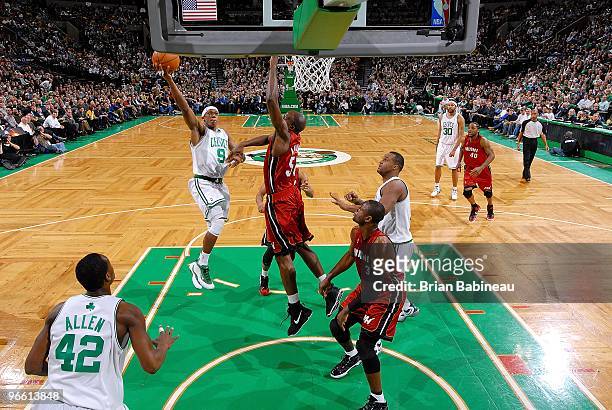 Rajon Rondo of the Boston Celtics hooks a shot over Joel Anthony of the Miami Heat during the game on February 3, 2010 at TD Banknorth Garden in...