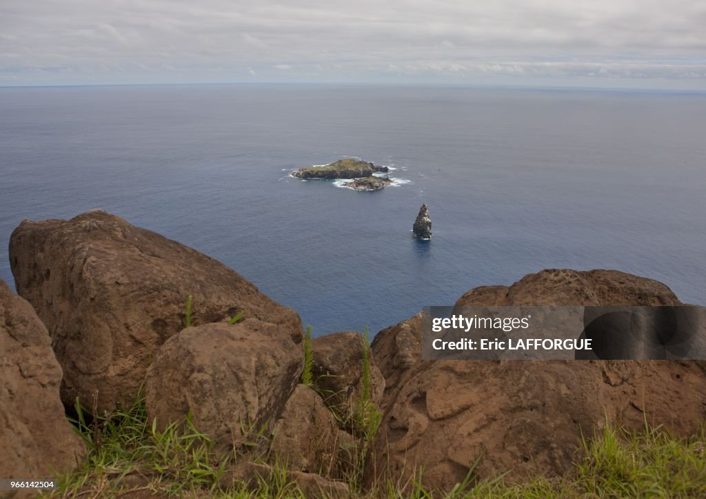 Orongo Rocks Petroglyphs on rocks at Orongo, overlooking the islands of Motu Nui ...