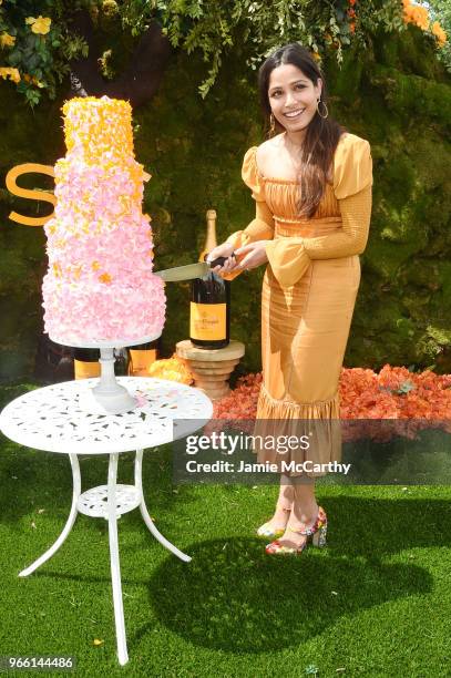 Freida Pinto cuts the cake during the 11th annual Veuve Clicquot Polo Classic at Liberty State Park on June 2, 2018 in Jersey City, New Jersey.