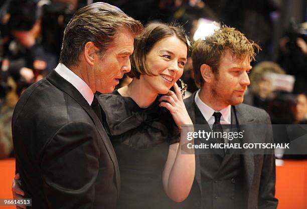 Irish actor Pierce Brosnan, British actress Olivia Williams and British actor Ewan McGregor pose for photographers as they arrive on the red carpet...