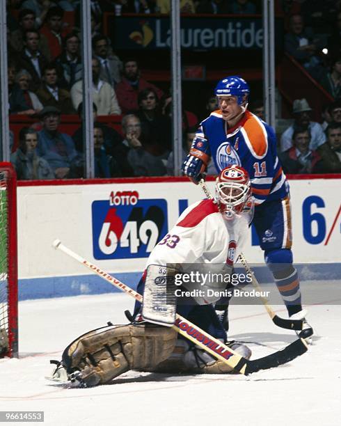 Mark Messier of the Edmonton Oilers positions himself to the left of goaltender Patrick Roy of the Montreal Canadiens in the 1980's at the Montreal...