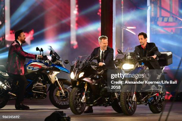 Bourne and Adrien Brody are seen on stage with their motorbikes during the Life Ball 2018 show at City Hall on June 2, 2018 in Vienna, Austria. The...