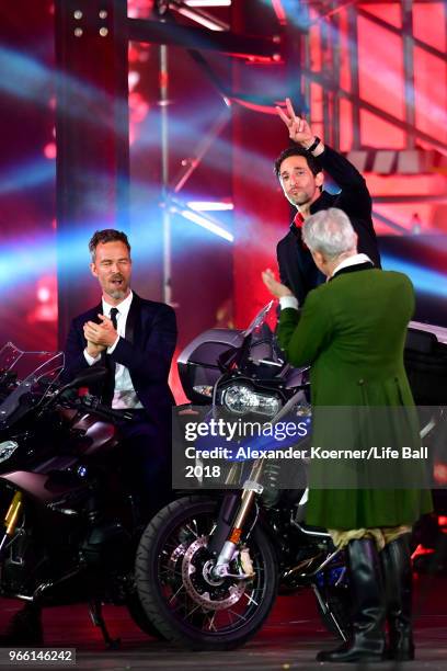 Bourne and Adrien Brody are seen on stage with their motorbikes during the Life Ball 2018 show at City Hall on June 2, 2018 in Vienna, Austria. The...