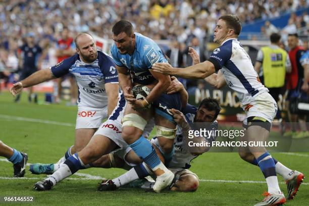 Montpellier's French number 8 Louis Picamoles is tackled during the French Top 14 final rugby union match between Montpellier and Castres at the...