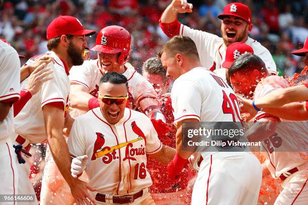 Kolten Wong of the St. Louis Cardinals is mobbed by his teammates after hitting a walk-off home run against the Pittsburgh Pirates in the ninth...