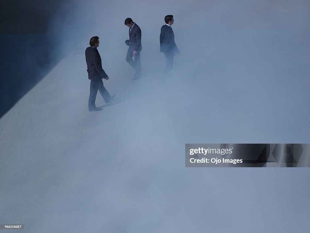 Businessmen walking in fog