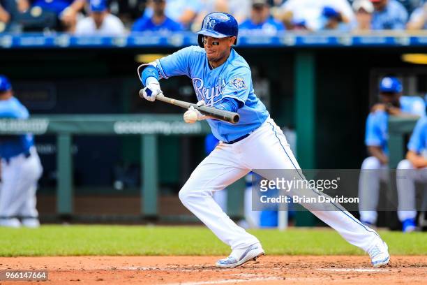 Ryan Goins of the Kansas City Royals bunts the ball during the fourth inning against the Oakland Athletics at Kauffman Stadium on June 2, 2018 in...
