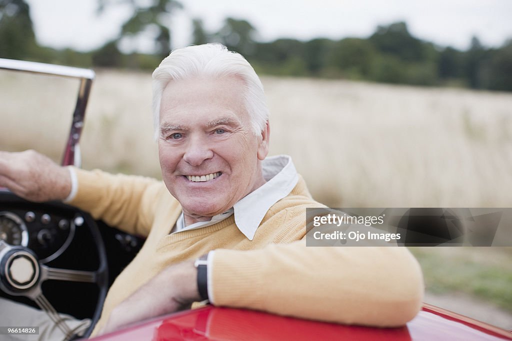 Man sitting in convertible car