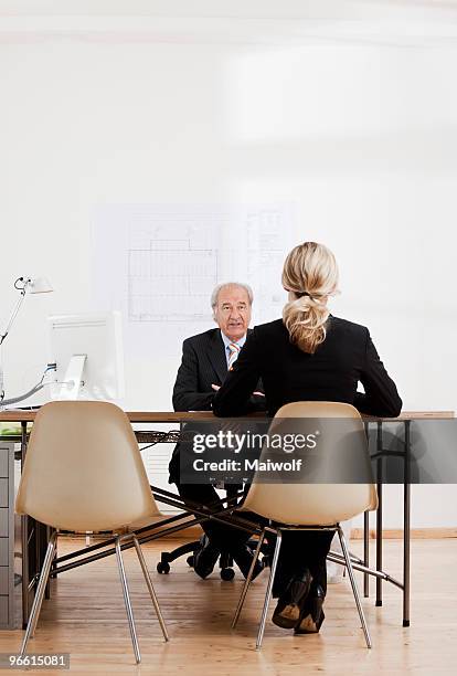 senior businessman talking to a woman - münchen immobilie büro stock-fotos und bilder